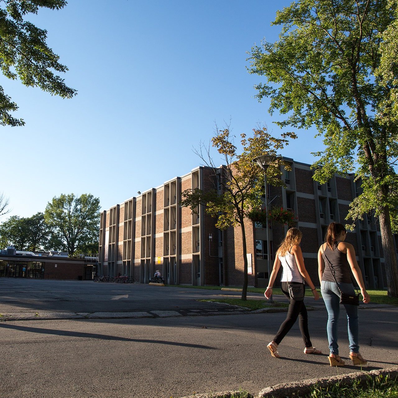 Two young women stroll past a building on Concordia University's Loyola Campus Two young women stroll past a building on Concordia University's Loyola Campus