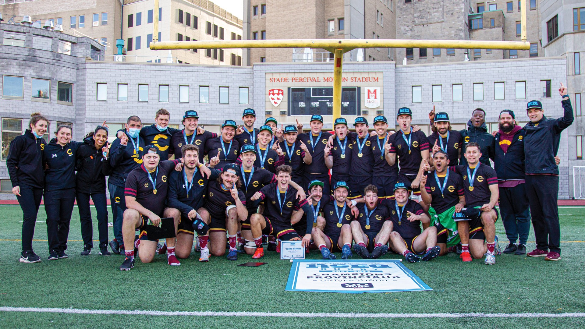 Men's rugby team posing on the McGill field