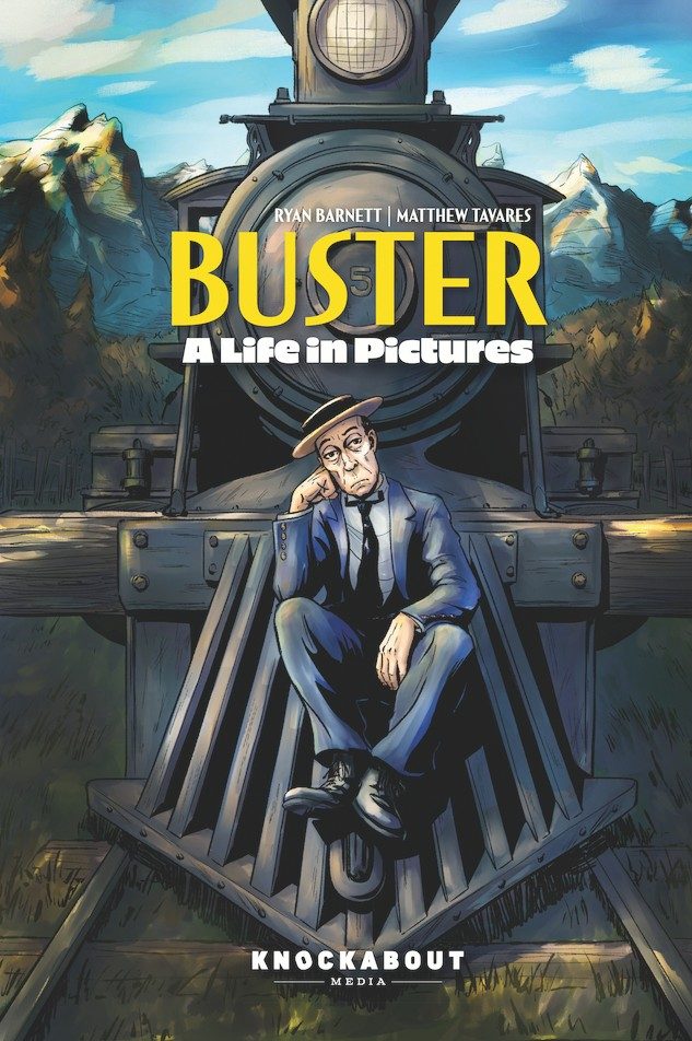 The cover of the book 'BUSTER: A Life in Pictures' by Ryan Barnett and Matthew Tavares. It features a comic-style illustration of a melancholic man in a blue suit sitting on train tracks with a vintage steam locomotive approaching in the background. The title is in bold yellow letters at the top, with 'KNOCKABOUT MEDIA' at the bottom.