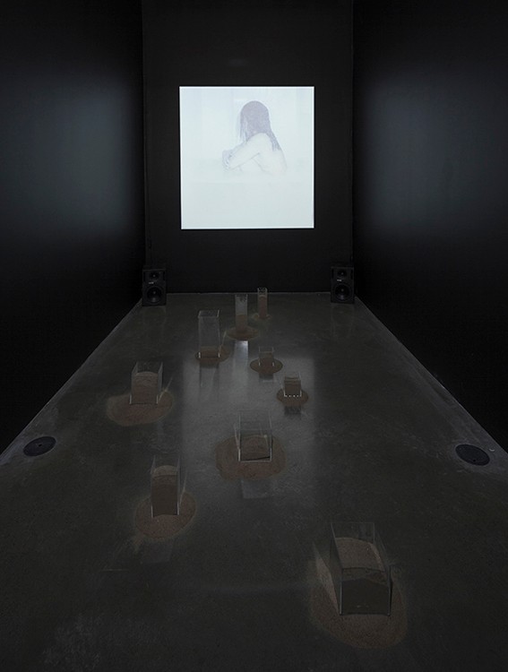 video projection, plexiglass boxes, sand, scaled to room