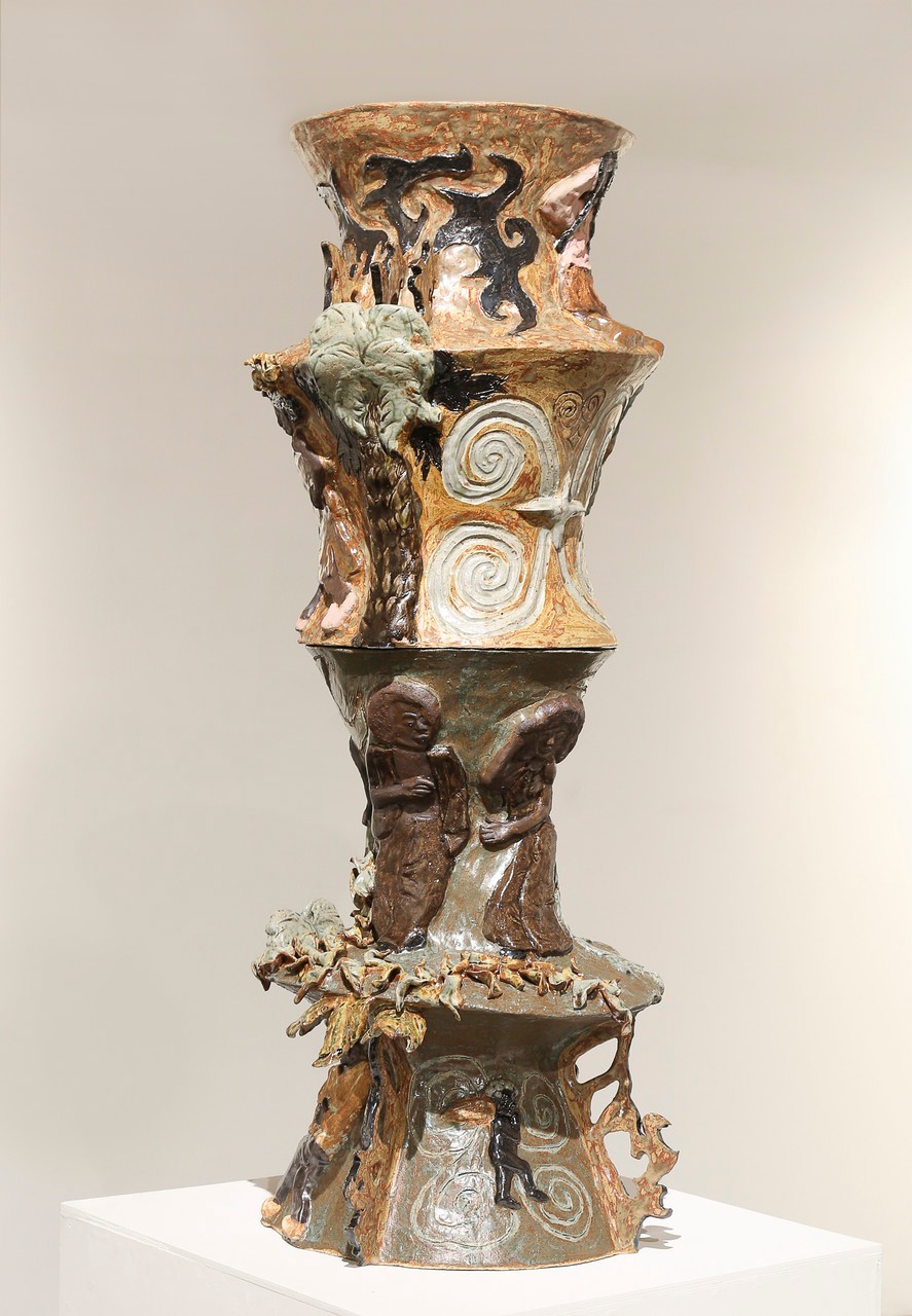 Another side of the ceramic vessel is shown as the different motifs are wrapped around the piece. The sculpture is divided in four sections. They depict individuals who are Afro-descendant resting, dancing, and performing other acts of self-care. 