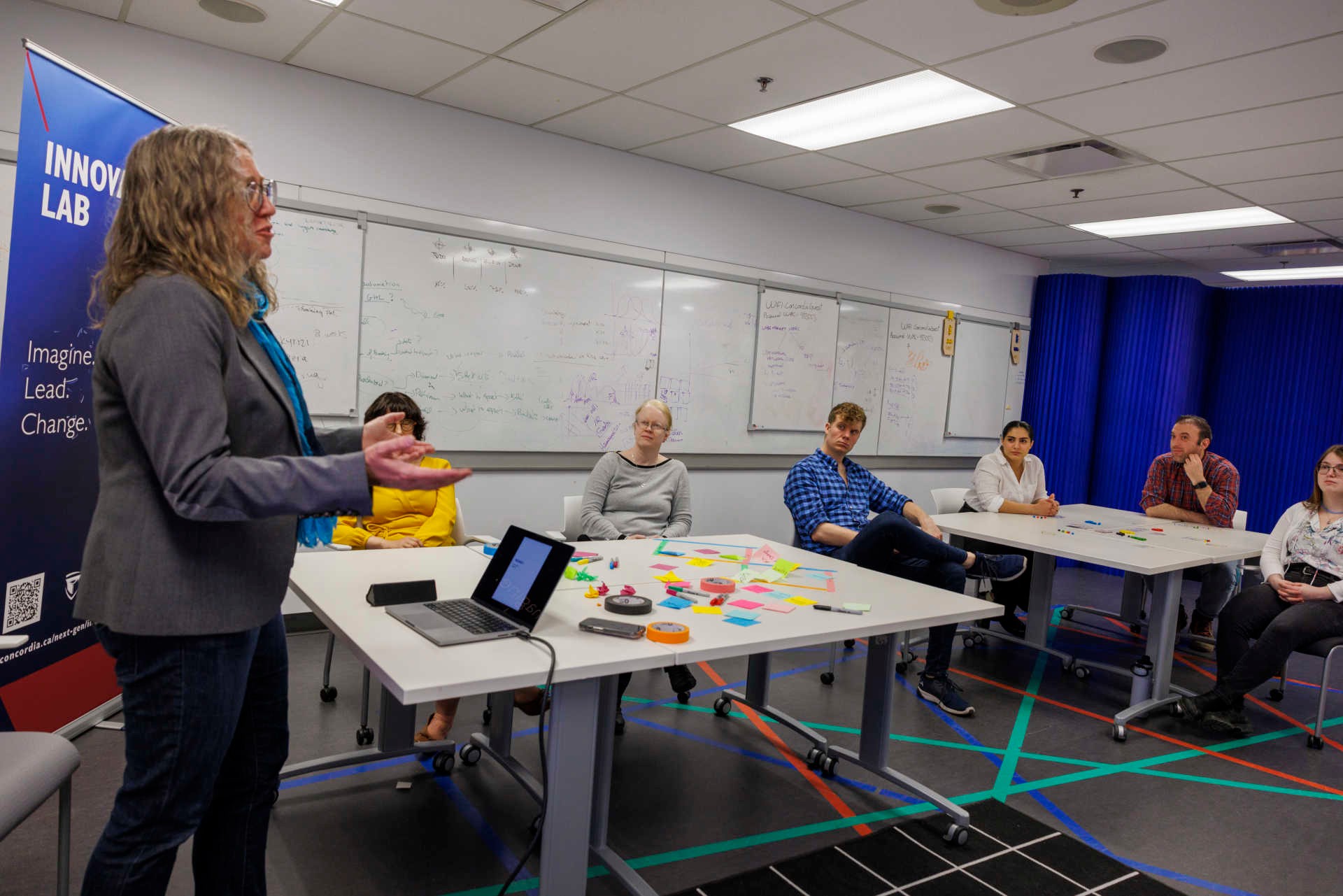 Professor Ann Louise Davidson addresses a group of students in the innovation lab