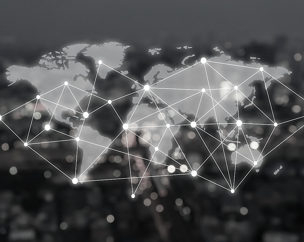 World map in black with white iridescent lines and lights connecting destinations