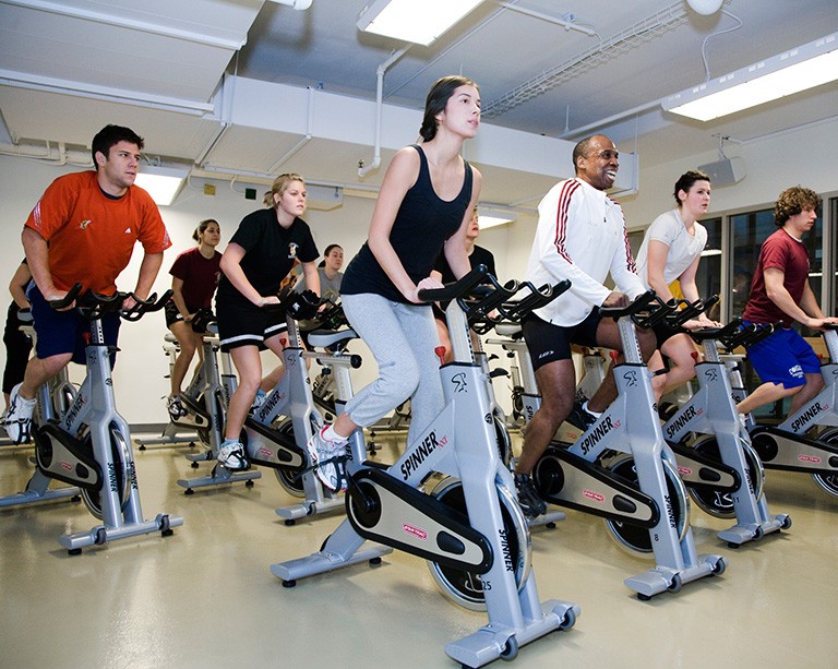 Riders participate in an indoor cycling class at Le Gym's Spin Studio, Concordia University's downtown fitness centre.
