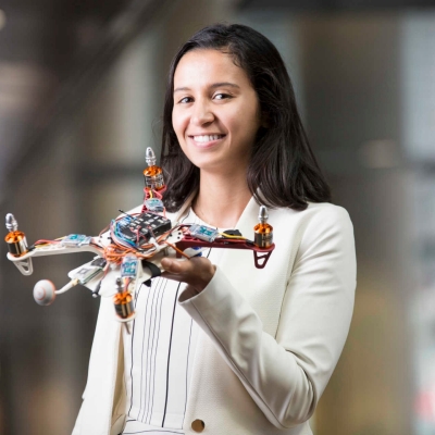 Screenshot of woman holding a drone, cropped to square