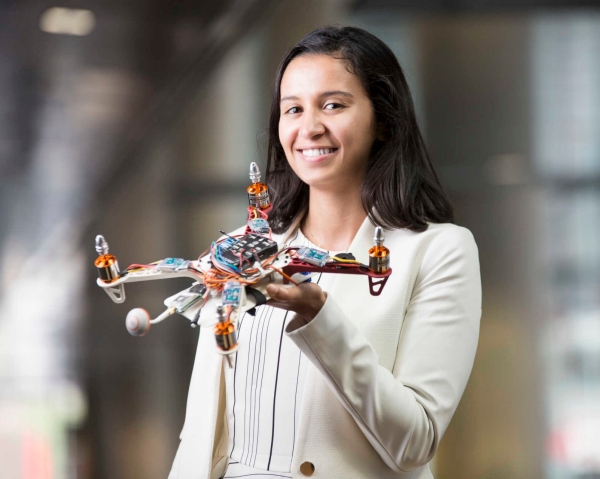 Screenshot of woman holding a drone, cropped to vignette