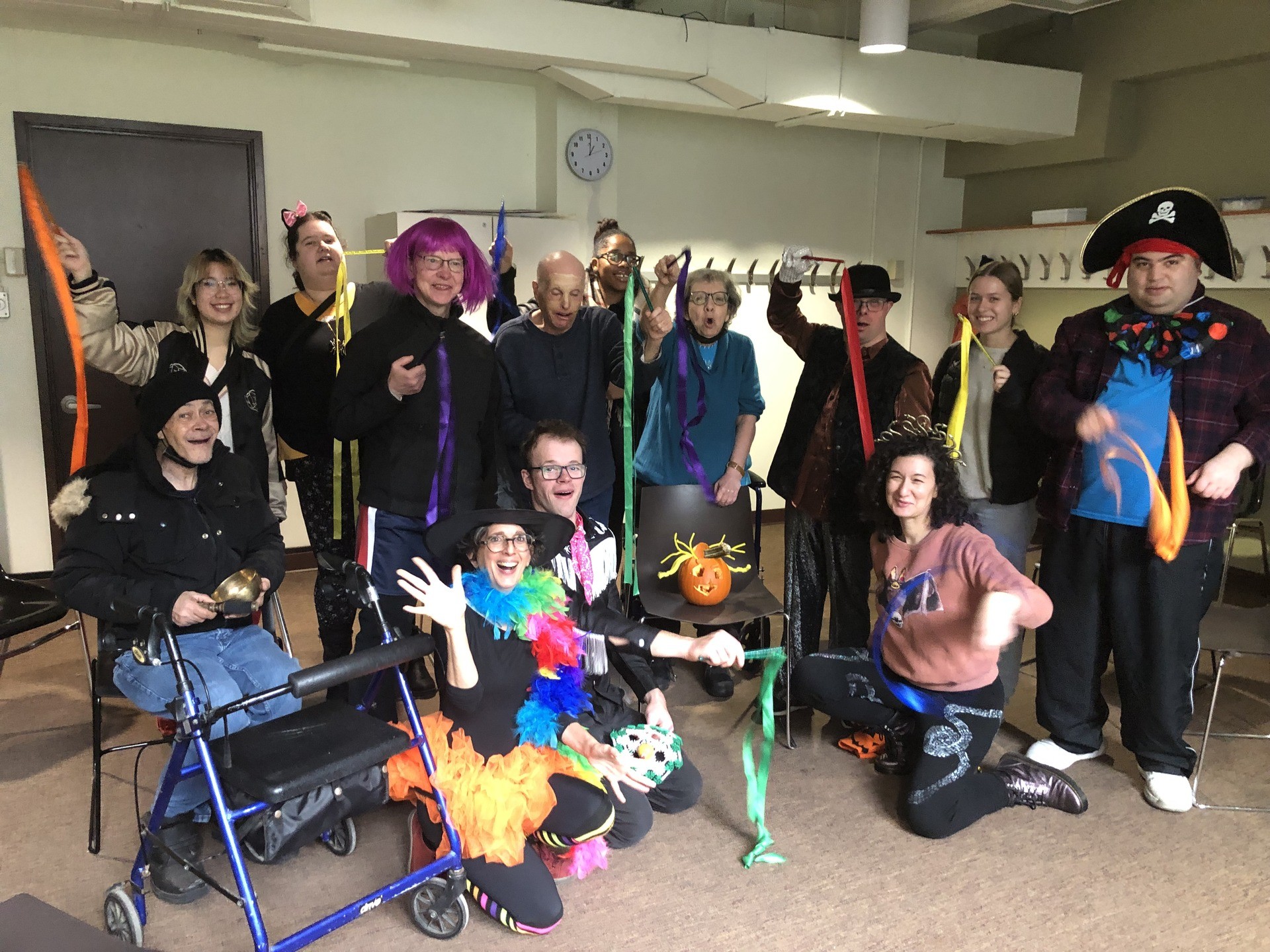 Group of adults, some dressed up, some with disabilities