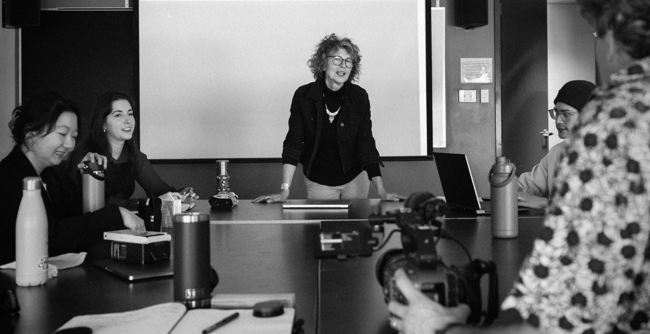 Black and white photo of woman prof in class