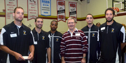 Concordia President Alan Shepard with members of the Stingers basketball team.