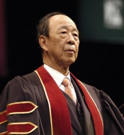 Man wearing academic robes over a shirt and tie