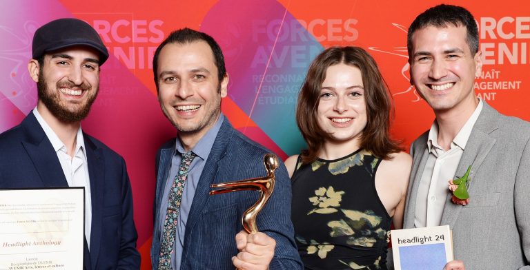 A group of people — three men and one woman — at an awards ceremony.