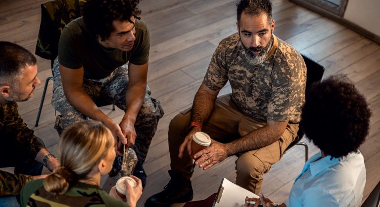 A diverse group of veterans in group therapy