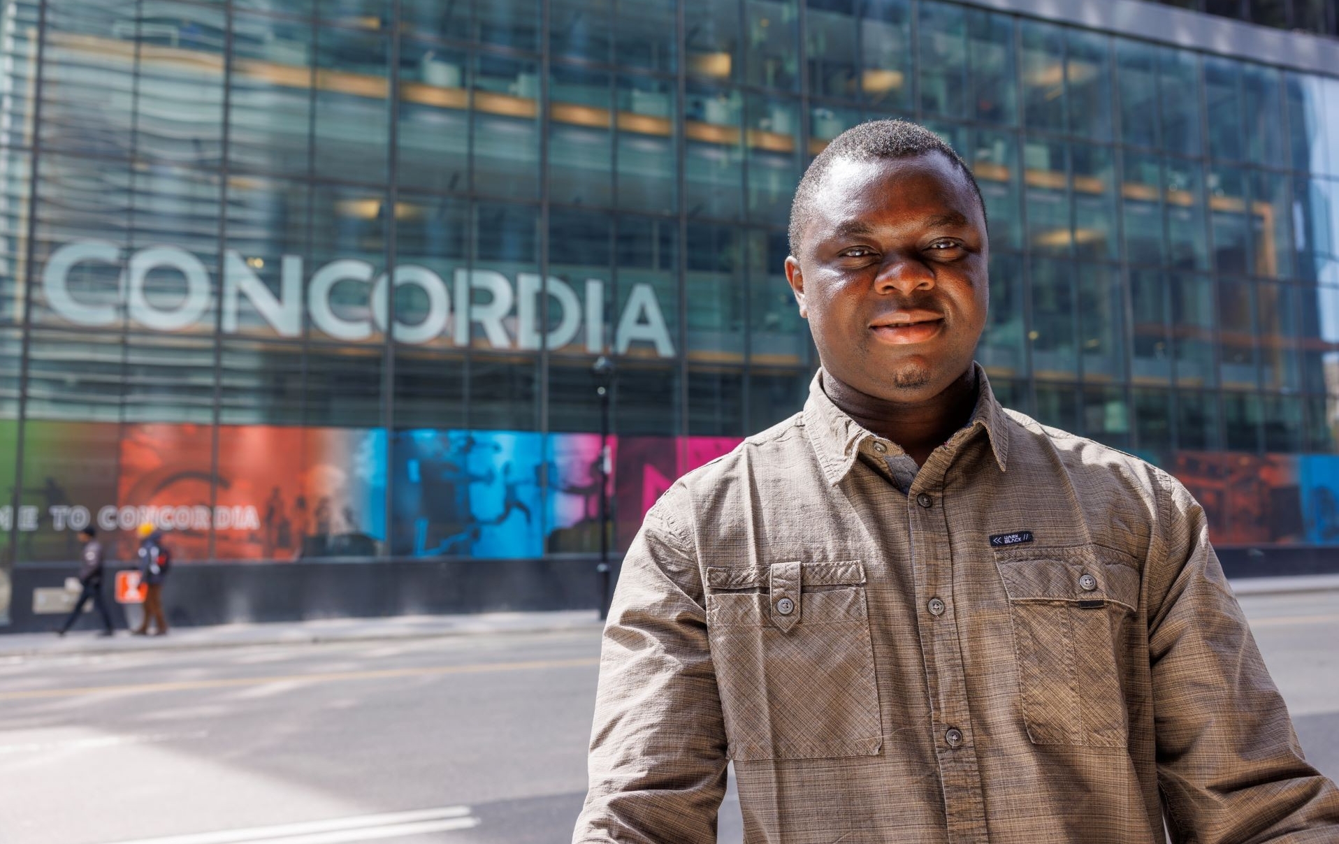 Akinlolu Ojo A man in a brown shirt stands outside Concordia University