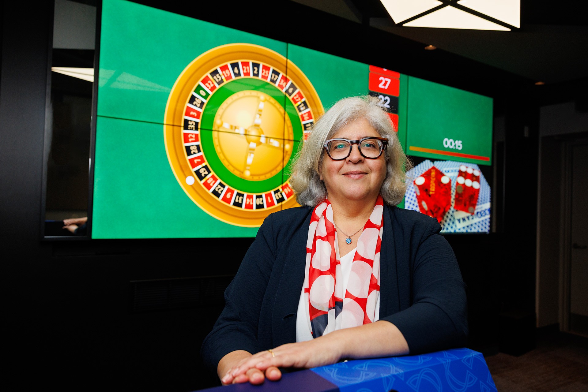 Syliva Kairouz Sylvia Kairouz in front of a simulated casino screen